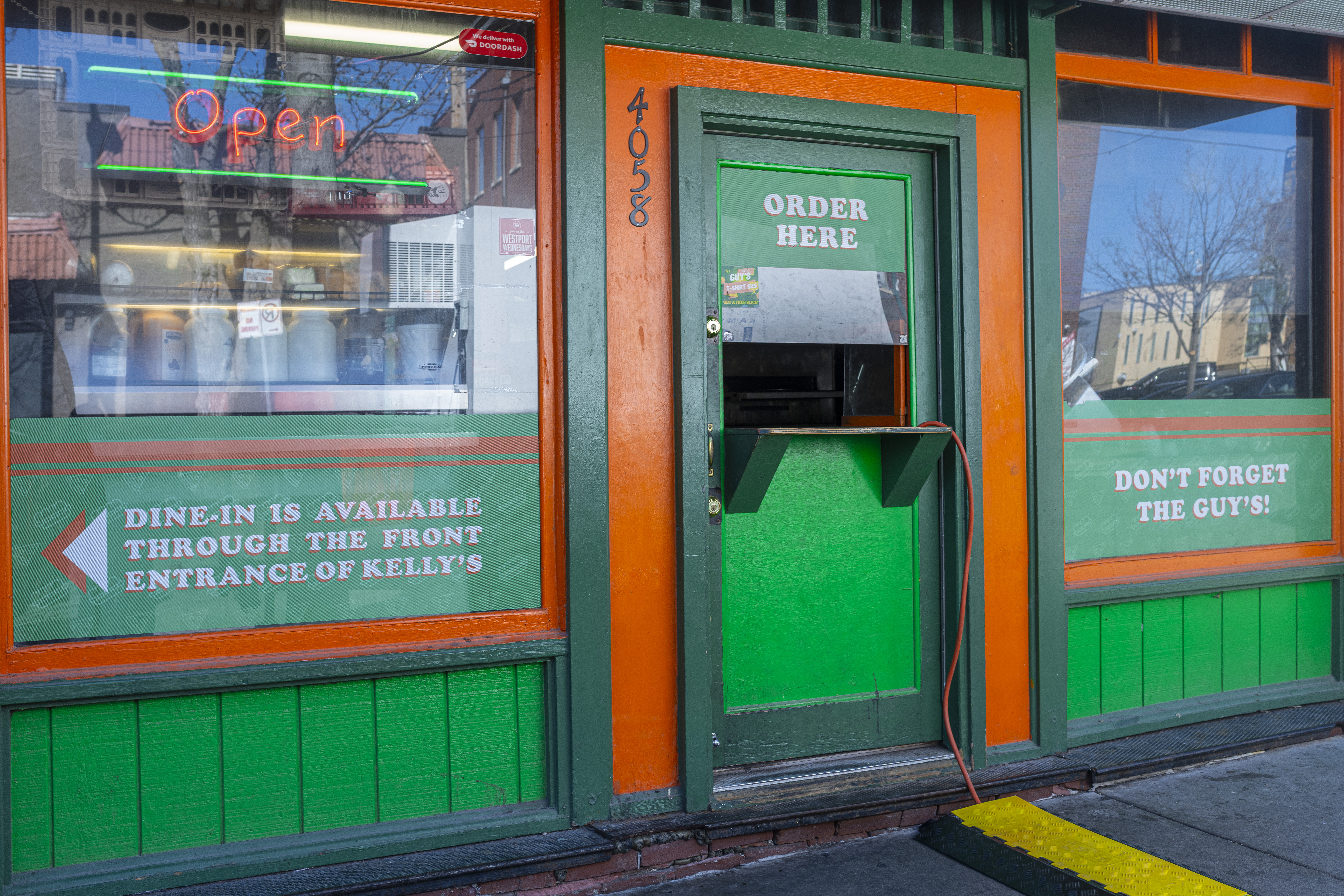Guy’s Deli’s green and orange order window at 4058 Pennsylvania Avenue in Westport